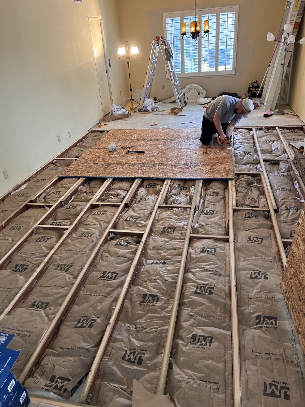 Subfloor panels going down over insulated sleepers before new flooring is laid
